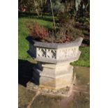 A cast octagonal garden planter, 80cm by 79cm high