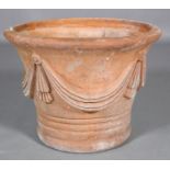 A terracotta garden planter, the tapered body moulded with swags, 54cm diameter x 42cm high