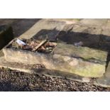 A stone trough, cut out to left hand side, rectangular, 94cm x 27cm x 15cm