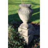 A cast garden urn with stepped base (cracked) 28cm by 79cm high