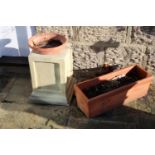 A cast garden plinth, 37cm high, and two terracotta pots, 52cm and 25cm wide