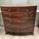 Early 19th century mahogany bow fronted chest of four long graduated drawers with rosette and ring