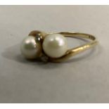 A pearl and diamond dress ring in 9ct gold, the 6mm cultured pearls and small eight cut diamonds set