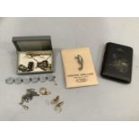 A collection of shakudo including cigarette box, tie back and two sets of cufflinks together with