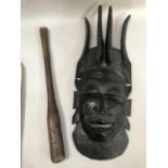 An ebonised carved wood facemask with coiffeur and antelope head dress, scarification to the