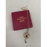 An Art nouveau pendant in 9ct gold of heart shaped outline, applied beads and foliate scrolls