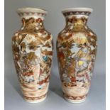A pair of Japanese pottery vases, enamelled and gilt with figures in landscapes, in iron red,
