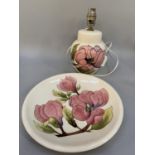 A Moorcroft lamp tube lined and glazed with pink magnolia on a cream ground, 22cm together with a
