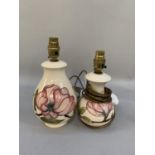 Two Moorcroft lamps, baluster, tube lined and glazed with pink magnolia on cream ground, 26cm and