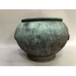 A Verdigris finished metal planter, circular with rope twist rim and two ring side handles, 32cm