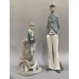 Two Lladro figures, sea captain with pipe 38cm high and boy reading with goats