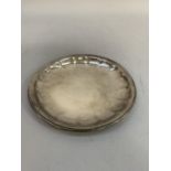 An early 19th century silver pin tray of circular outline with indented bowl, engraved to the