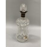 A silver collared and four lipped decanter with ovoid shaped cut stopper and waisted body, cut to