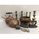 A pair of ornate candlesticks, silver plate on copper, a pair of brass candlesticks and another