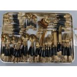 A suite of gilt and horn handled cutlery from Thailand comprising dinner knives and forks, fish
