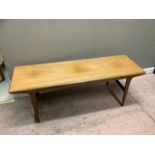 A 1970's teak coffee table, rectangular on tapered legs, 137cm by 145cm