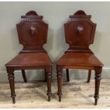 Pair 19th century mahogany hall chairs with shield shaped back on turned legs