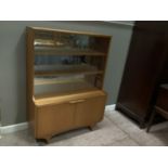 A book case cabinet with sliding glass doors above two door cupboard