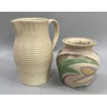An early Susie Cooper jug, the cream body of slight baluster form with ribbed decoration above a