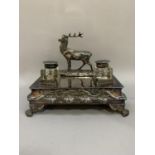 A Victorian Britannia metal desk standish of rectangular outline mounted with a stag and fitted with