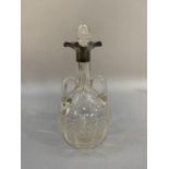A George V cut glass decanter with three lipped silver spout, baluster form and three looped
