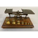 A set of late Victorian/late Edwardian postal scales by Windle & Blyth on a mahogany base with seven