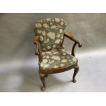 An 18th century style oaken armchair in walnut having upholstered back bowed seat on cabriole legs
