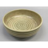An early Susie Cooper bowl, circular with ribbed sides, the well incised with concentric circles and