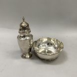 A George VI silver sugar shaker of decagonal outline over facetted foot with tulip finial,