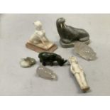 An Innuit carving in soapstone by Newkinga of a walrus with marine ivory together with small