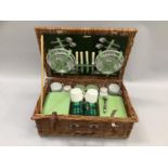 A wicker picnic hamper complete with crockery, cutlery, tupperware and flasks
