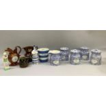 Four Staffordshire blue and white patterned kitchen storage jars together with matching jug, Cornish
