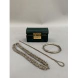 Two neck chains and a bangle all in white metal, tests as .800 continental silver, in a green