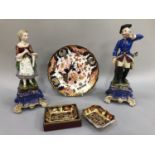 A pair of continental figures on ornate blue and gilt bases modelled as man and woman in 18th