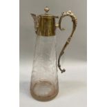 An early 20th century silver plate mounted claret jug, the tapered cylindrical body engraved with