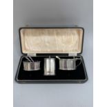 A George VI three piece silver condiment set all of oval outline with reeded rim and foot,