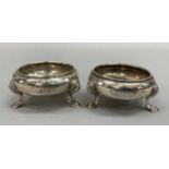 A pair of George II silver salts, circular baluster form on three pad feet, hallmarked London 1704