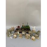 A collection of Lilliput Lane cottages, windmill, together with a resin model of a tractor, farmer