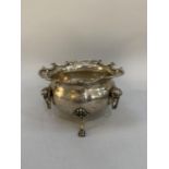 An Edward VII silver sugar bowl, baluster form with mashed hinge handles, C scroll rim and three