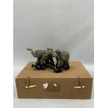 A pair of Chinese jade style elephants, hardwood stands contained within original presentation case,