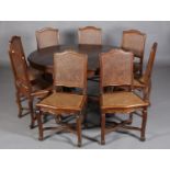AN EARLY 20TH CENTURY FRENCH PROVINCIAL CHESTNUT DINING TABLE AND EIGHT BERGERE CANED CHAIRS, the