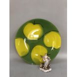 A yellow and green glass plate, circular, printed with apples, 41cm diameter together with a