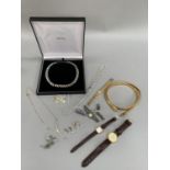A collection of costume jewellery including three ladies and one gentleman’s wrist watch,