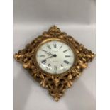 A wall clock, circular white dial with Roman and Arabic numerals, gilt carved and pierced frame of