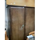 A Stag Minstrel two door wardrobe, fitted with a shelf