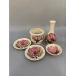 Five Moorcroft magnolia pattern items including vase, small planter and three pin trays