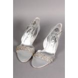 Gina: pair of open-toe silver leather sling backs, the front cross-over strap shaped as if