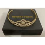 A tiara by Butler and Wilson in gilt base metal, all over claw set with circular colourless foil