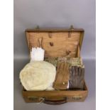 A brown leather dressing case, containing an ermine hat with egret feather, a sewing bag and