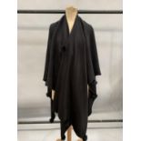 A large, shaped, black wool wrap trimmed with fox